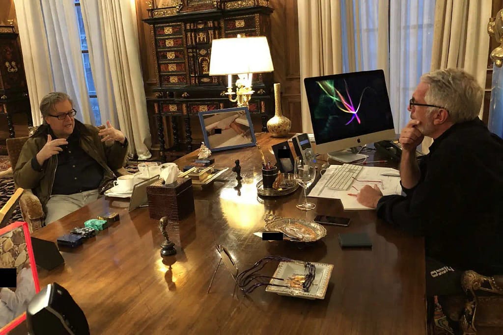 Photograph showing Jeffrey Epstein at a gathering with multiple people, several faces redacted.