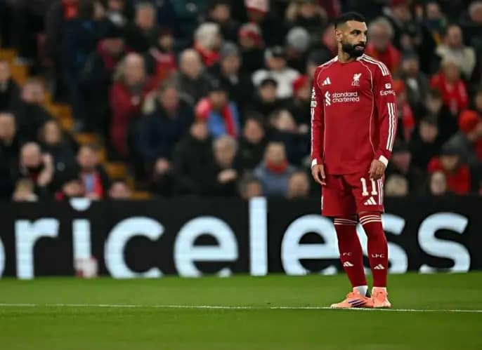 A dejected Liverpool player walks across the pitch at Anfield after the defeat.